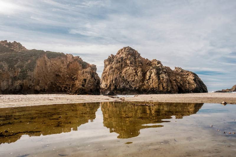 Sea stack reflections at Pfeiffer Beach in Big Sur California