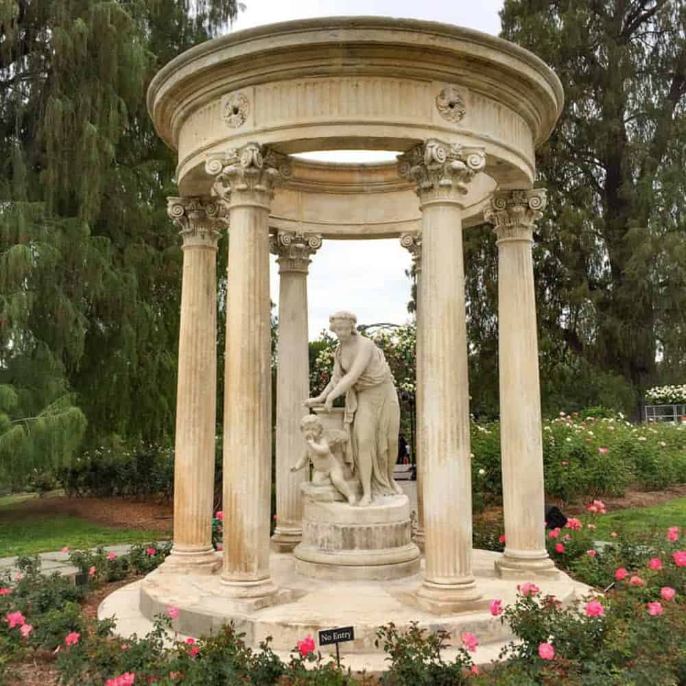 A tempietto in the Rose Garden at the Huntington with statues of Cupid and his captor.