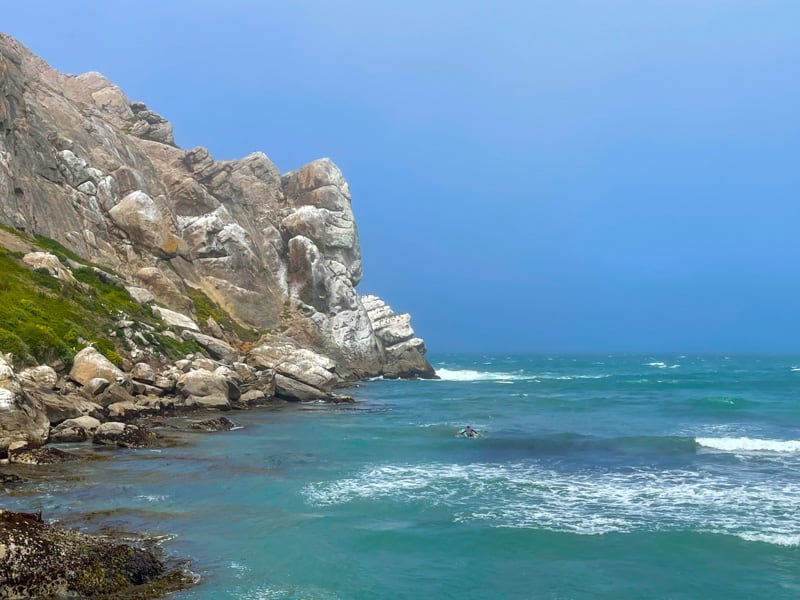 Surfer at Morro Rock in Morro Bay, CA